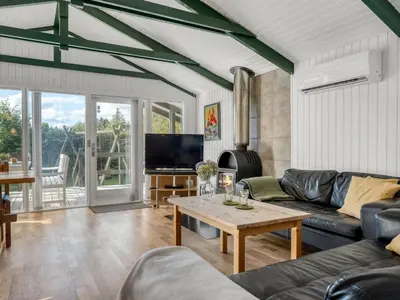 a living room with a couch and a table at Holiday Home Inola - 3-5km from the sea by Interhome in Fjerritslev