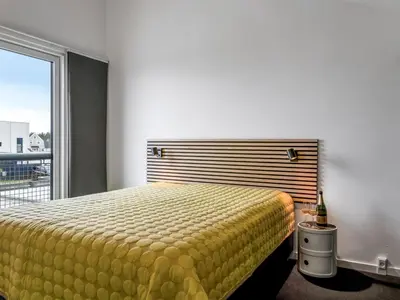 a bedroom with a bed and a large window at Holiday Home Adelbrand - 1km from the sea by Interhome in Blokhus