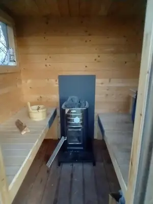 an inside view of a sauna with a stove at Apartment with water views in Fjerritslev