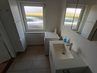 a small bathroom with a sink and a window at Apartment with water views in Fjerritslev