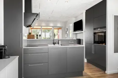 a kitchen with gray cabinets and a sink at G346-Lemvig-Vinkelhagevej-46 in Lemvig