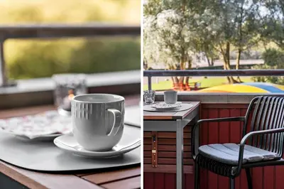 a table with a coffee cup and a chair on a balcony at G346-Lemvig-Vinkelhagevej-46 in Lemvig