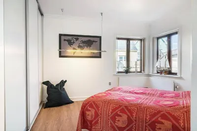 a bedroom with a bed with a red blanket at 719-Thyboron-Fanovej-3 in Thyborøn