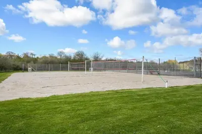 a volleyball court with a net in a field at G186-Lemvig-Vinkelhagevej-186 in Lemvig