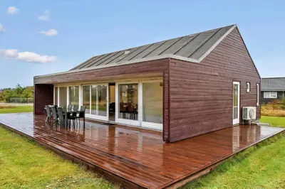 a house on a deck with a solarium at JB362-Brovst-Kronvildtvej-136 in Brovst