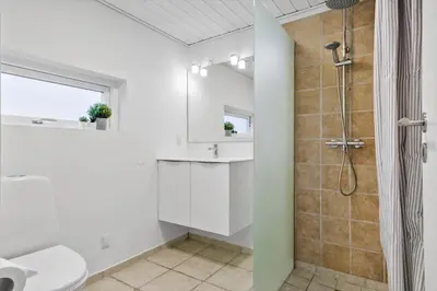 a bathroom with a shower and a toilet and a sink at JB362-Brovst-Kronvildtvej-136 in Brovst