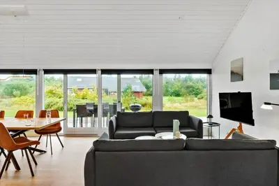 a living room with a couch and a table at JB362-Brovst-Kronvildtvej-136 in Brovst