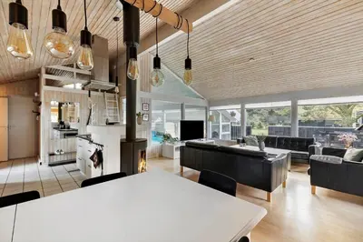 a kitchen and living room with a table and chairs at BL1129-Saltum-Ornebjergvej-6 in Saltum