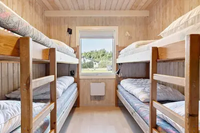 a bunk bed room with four bunk beds and a window at BL1129-Saltum-Ornebjergvej-6 in Saltum