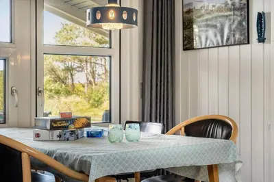 a dining room table with chairs and a window at 1334-Thisted-Ingerslevvej-14 in Thisted
