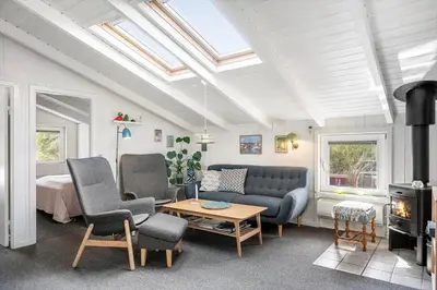 a living room with a couch and chairs and a stove at 1334-Thisted-Ingerslevvej-14 in Thisted