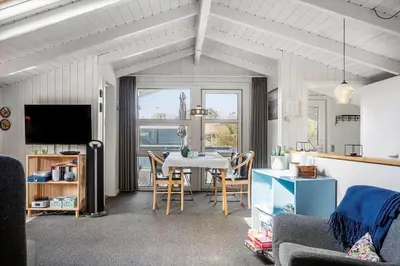 a living room with a table and chairs and a tv at 1334-Thisted-Ingerslevvej-14 in Thisted