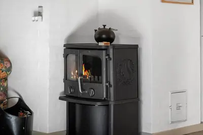 a small stove in a corner of a room at 852-Bedsted-Thy-Istrupvej-35 in Bedsted Thy