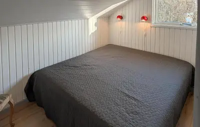 a bedroom with a bed in the corner of a room at Amazing Home In Spøttrup With House A Panoramic View in Spottrup