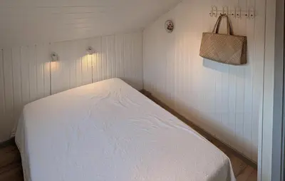 a small bedroom with a white bed in a room at Amazing Home In Spøttrup With House A Panoramic View in Spottrup