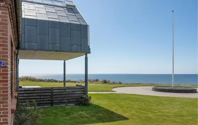 a building with a view of the ocean at 4 Bedroom Beach Front Home In Vinderup in Vinderup