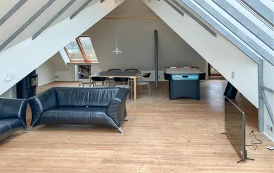 a living room with a couch and a table in a attic at 4 Bedroom Beach Front Home In Vinderup in Vinderup