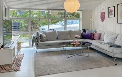 a living room with a couch and a table at Lovely Home In Fjerritslev With Wifi in Fjerritslev