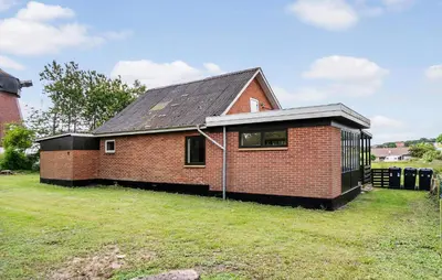 a red brick house with a black roof at 1 Bedroom Nice Home In Hurup Thy in Ullerup
