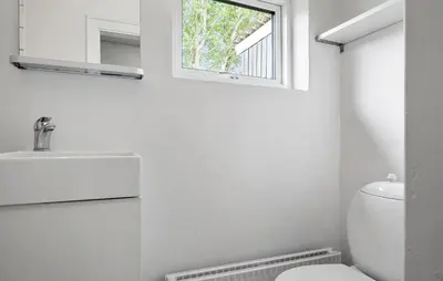 a bathroom with a white toilet and a window at 1 Bedroom Nice Home In Hurup Thy in Ullerup