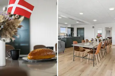 a kitchen and a dining room with a table with a loaf of bread at 820-Harboore-Bjergehusvej-19 in Harboør