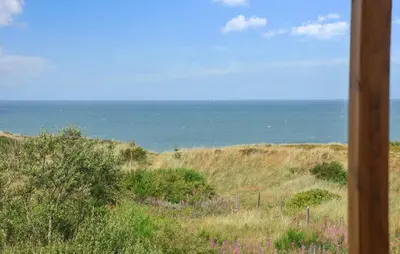 a view of the ocean from a field of grass at Nice Home In Hanstholm With House Sea View in Hanstholm