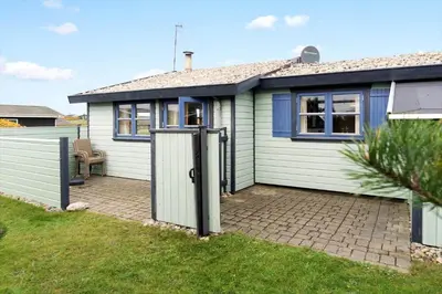a white house with a gate in the yard at 1069-Thisted-Kobbelsti-23 in Thisted