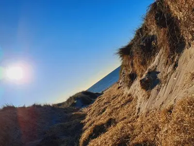 a dirt hill with grass on the side of it at 4 star holiday home in Harboøre in Harboør