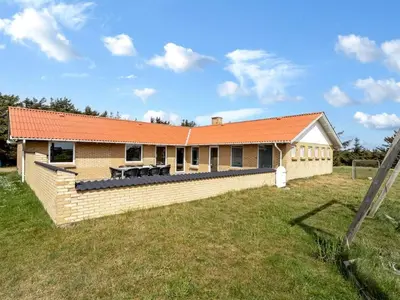 a house with an orange roof on a field at 4 star holiday home in Harboøre in Harboør