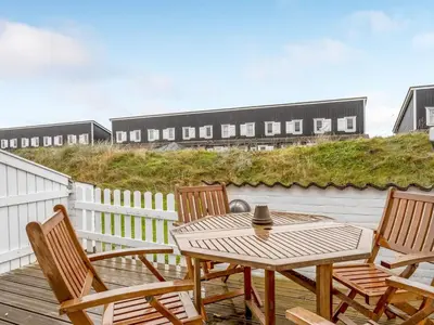 a patio with a table and chairs on a deck at Apartment Benthe - 100m to the fjord by Interhome in Vestervig
