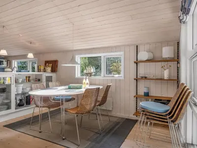 a kitchen with a white table and chairs at Holiday Home Peder - 4km from the sea by Interhome in Fjerritslev