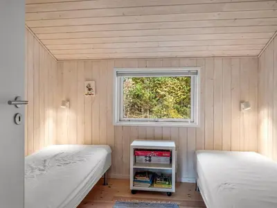 a small room with two beds and a window at Holiday Home Peder - 4km from the sea by Interhome in Fjerritslev
