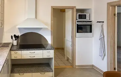 a kitchen with a stove top oven in a kitchen at 5 Bedroom Awesome Home In Lemvig in Lemvig