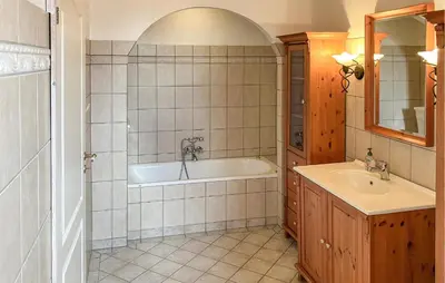 a bathroom with a tub and a sink at 5 Bedroom Awesome Home In Lemvig in Lemvig