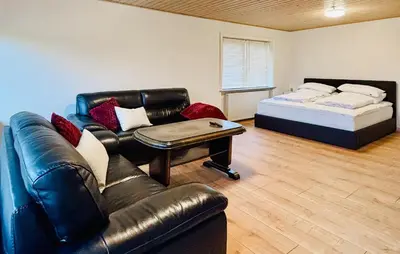 a living room with a couch and a bed at 5 Bedroom Awesome Home In Lemvig in Lemvig