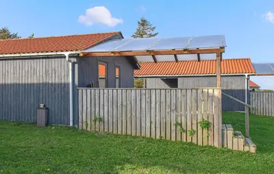 a house with a fence in front of it at Gorgeous Home In Hanstholm With Swimming Pool in Hanstholm