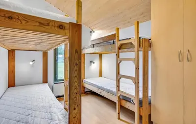 a bedroom with two bunk beds and a ladder at Beautiful Home In Hanstholm With Swimming Pool in Hanstholm