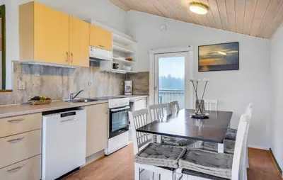 a kitchen with a table and a dining room at Beautiful Home In Hanstholm With Swimming Pool in Hanstholm