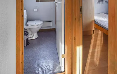 a bathroom with a toilet and a door open at Beautiful Home In Hanstholm With House A Panoramic View in Hanstholm
