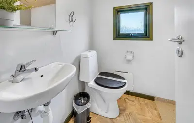a bathroom with a toilet and a sink at Lovely Home In Hanstholm With Private Swimming Pool, Can Be Inside Or Outside in Hanstholm