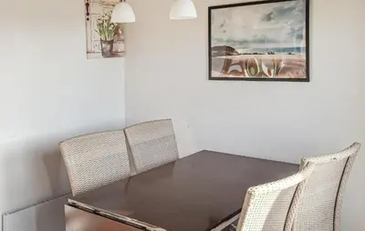 a dining room with a table and two chairs at Stunning Home In Hanstholm With Outdoor Swimming Pool in Hanstholm
