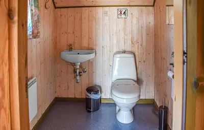 a small bathroom with a toilet and a sink at Stunning Home In Hanstholm With Outdoor Swimming Pool in Hanstholm