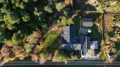an overhead view of a building in a forest at Cozy Cottage Close To Thy National Park in Thisted