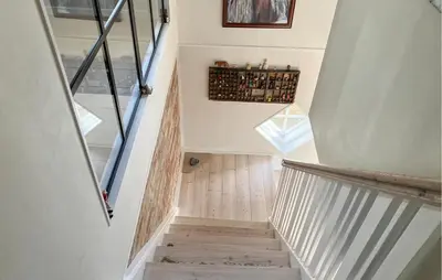 a staircase in a home with white walls and wood floors at 2 Bedroom Stunning Home In Lemvig in Lemvig