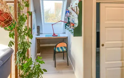 a tiny house with a desk and a chair at 2 Bedroom Stunning Home In Lemvig in Lemvig