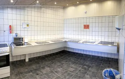 a kitchen with white tiled walls and a counter at Beautiful Home In Hanstholm With Swimming Pool in Hanstholm