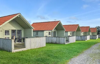 a row of green houses with red roofs at Beautiful Home In Hanstholm With Swimming Pool in Hanstholm