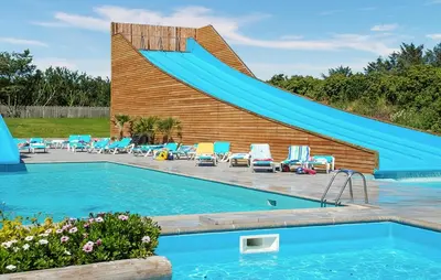 a swimming pool with a slide in front of a house at 2 Bedroom Stunning Home In Hanstholm in Hanstholm