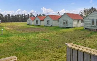 a row of houses with red roofs in a field at 2 Bedroom Stunning Home In Hanstholm in Hanstholm