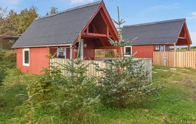 a red house with a black roof and a fence at 1 Bedroom Cozy Home In Hanstholm in Hanstholm
